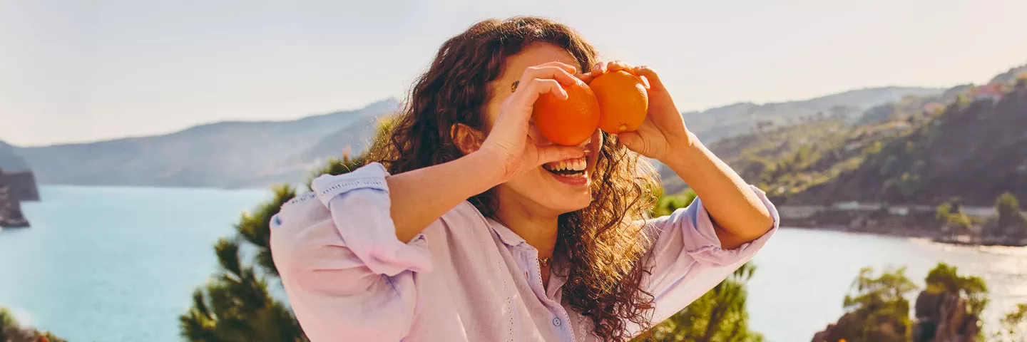 girl laying with oranges