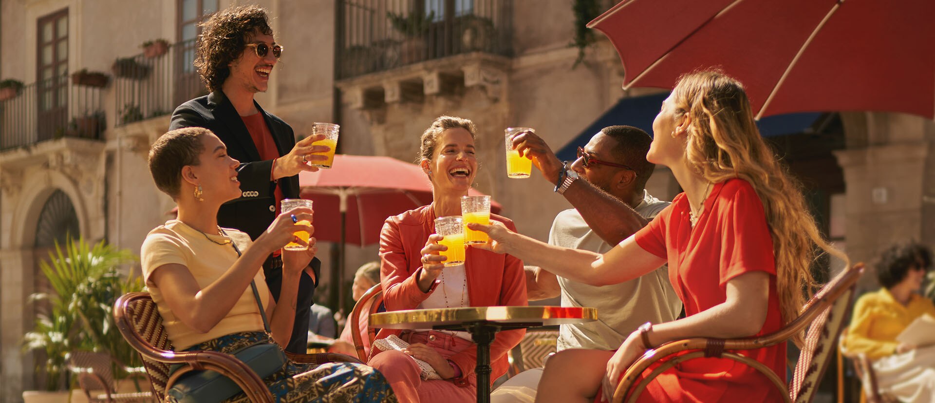 Happy friends having an aperitif with Sanpellegrino Sparkling Drinks