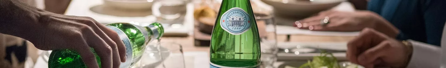 Table with S.Pellegrino Mineral Water in glass bottle