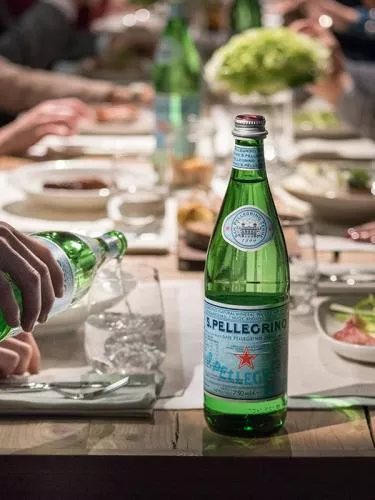 Bottle of S.Pellegrino water on a table during a lunch
