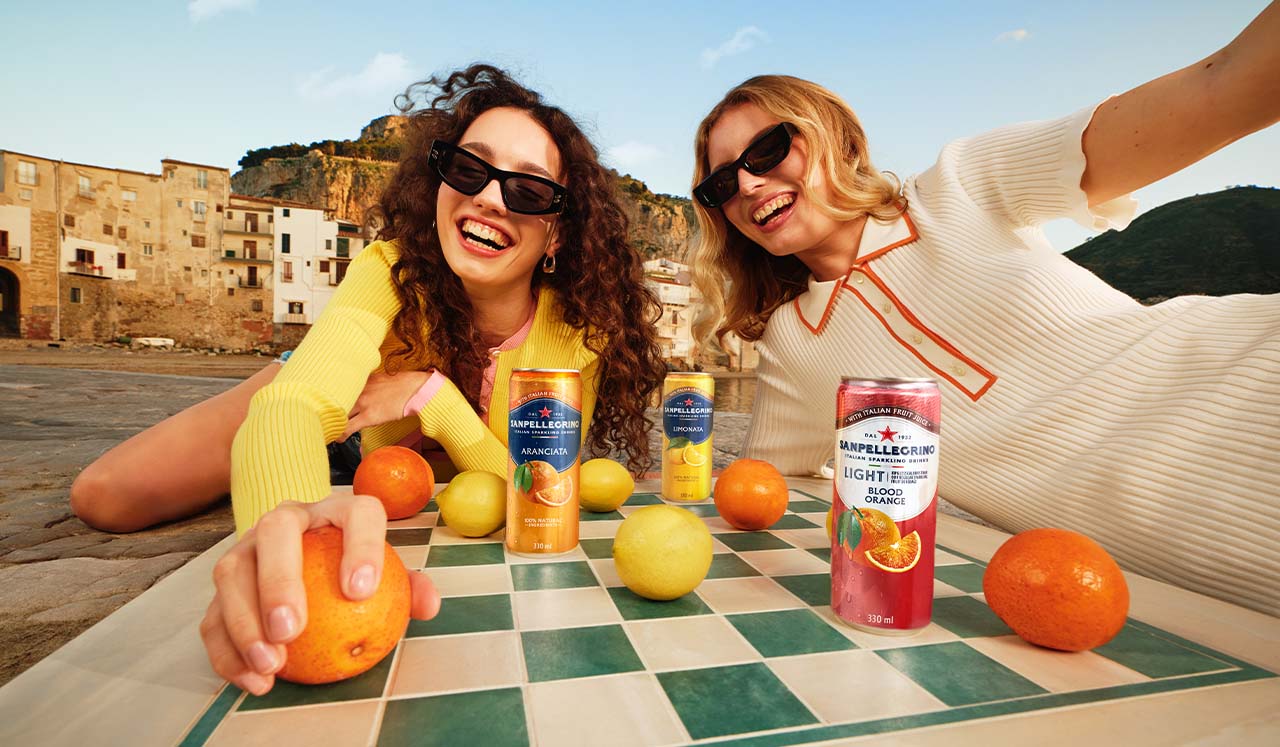 two smiling girls with sanpellegrino italian sparkling drinks