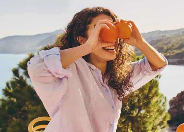 girl laying with oranges