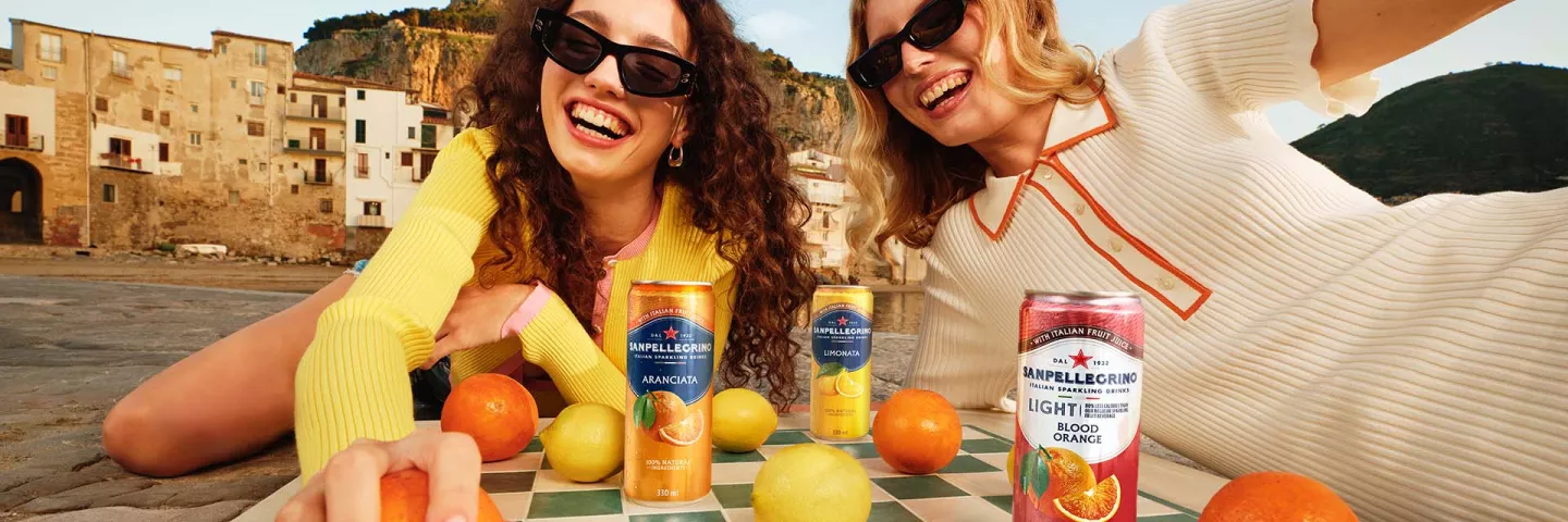 two smiling girls with sanpellegrino italian sparkling drinks