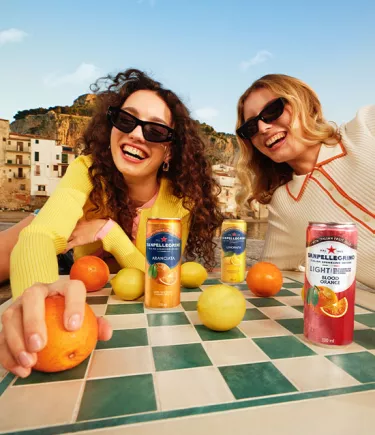 two smiling girls with sanpellegrino italian sparkling drinks mobile