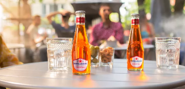 Cocktail Sanpellegrino glass bottles on a table