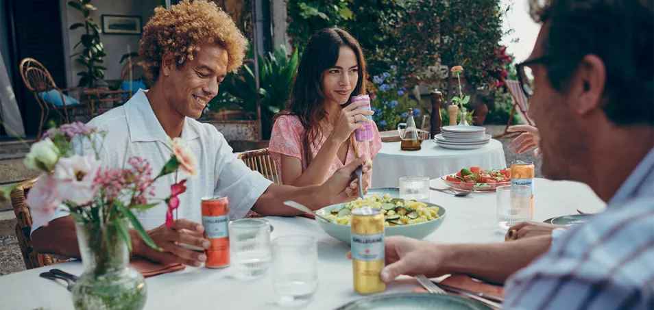 People dining outdoors with S.Pellegrino Essenza