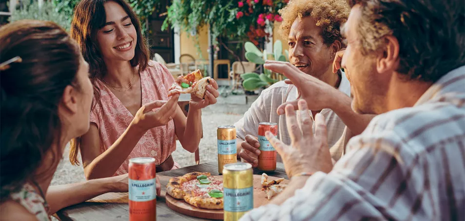 People dining outdoors with S.Pellegrino Essenza