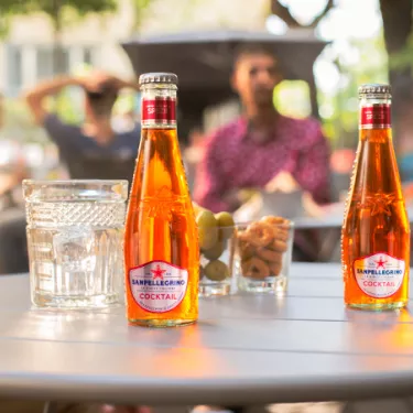 Cocktail Sanpellegrino glass bottles on a table