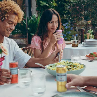 People dining outdoors with S.Pellegrino Essenza