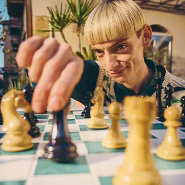 gars joue aux échecs avec des oranges