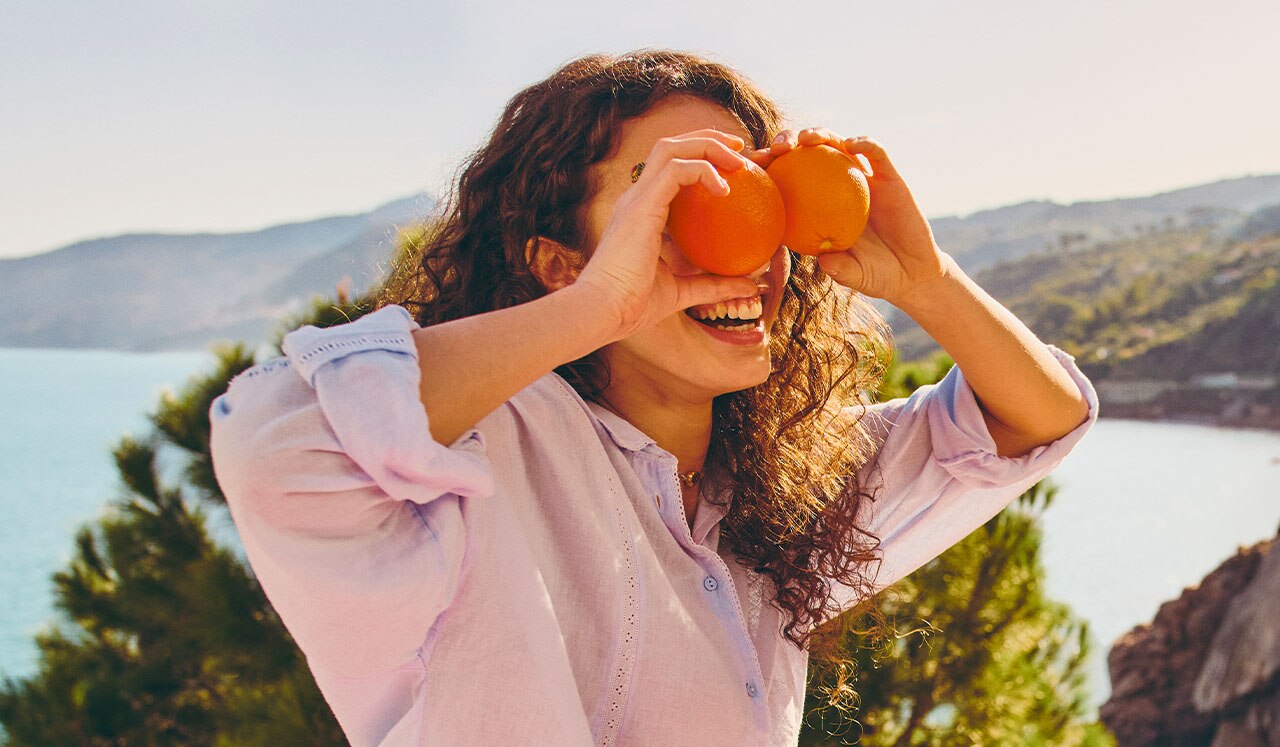 girl playing with oranges