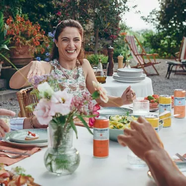 People dining outdoors with S.Pellegrino Essenza