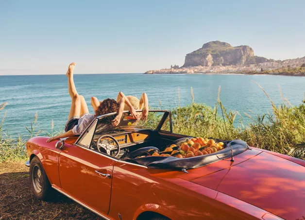 two girls relaxing on-a convertible car