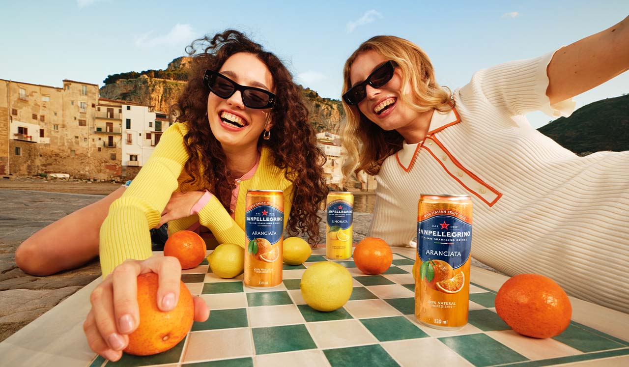 two smiling girls with sanpellegrino italian sparkling drinks