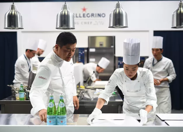 Chef teaching to a young talent in S.Pellegrino Academy