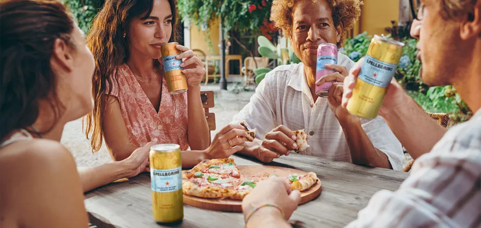 Friends sharing pizza and S.Pellegrino Essenza outdoors