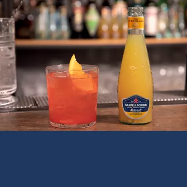 sanpellegrino garibaldi cocktail with aranciata glass