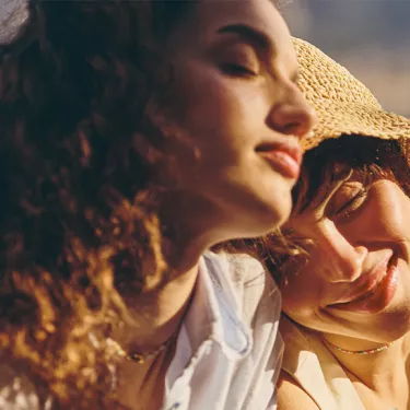 girls relaxing by seaside