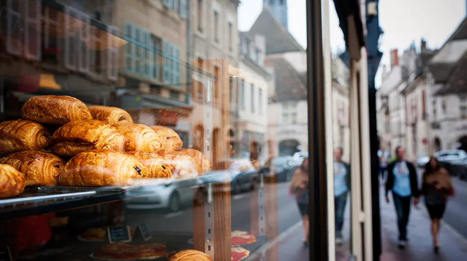Closeup of a shop window displaying some croissants