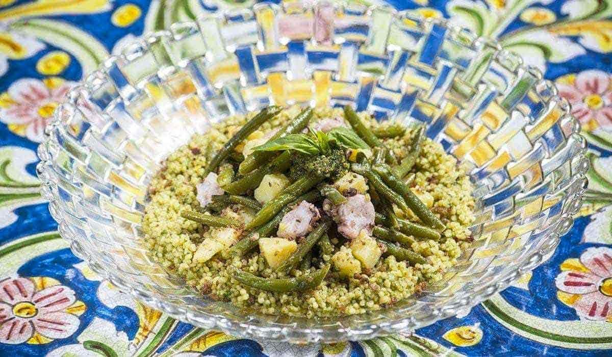 A modern update of the traditional couscous dish with Octopus, basil pesto and olives