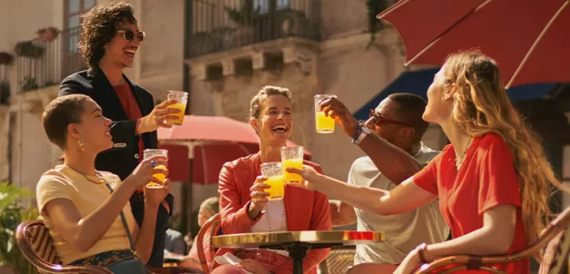 People toasting with Sanpellegrino Aranciata