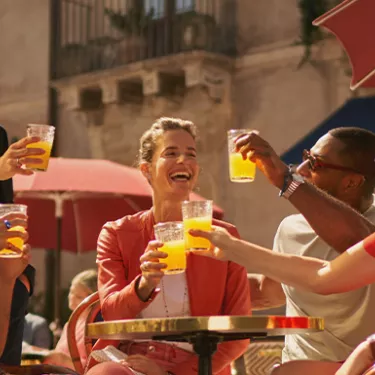People toasting with Sanpellegrino Aranciata