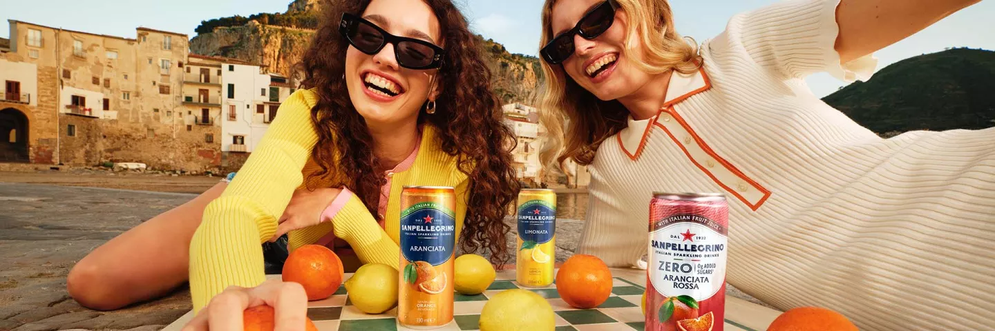 two smiling girls with sanpellegrino italian sparkling drinks