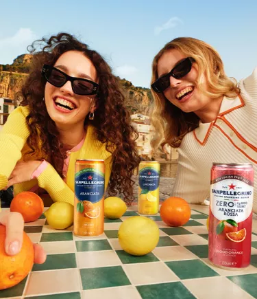 two smiling girls with sanpellegrino italian sparkling drinKS mobile