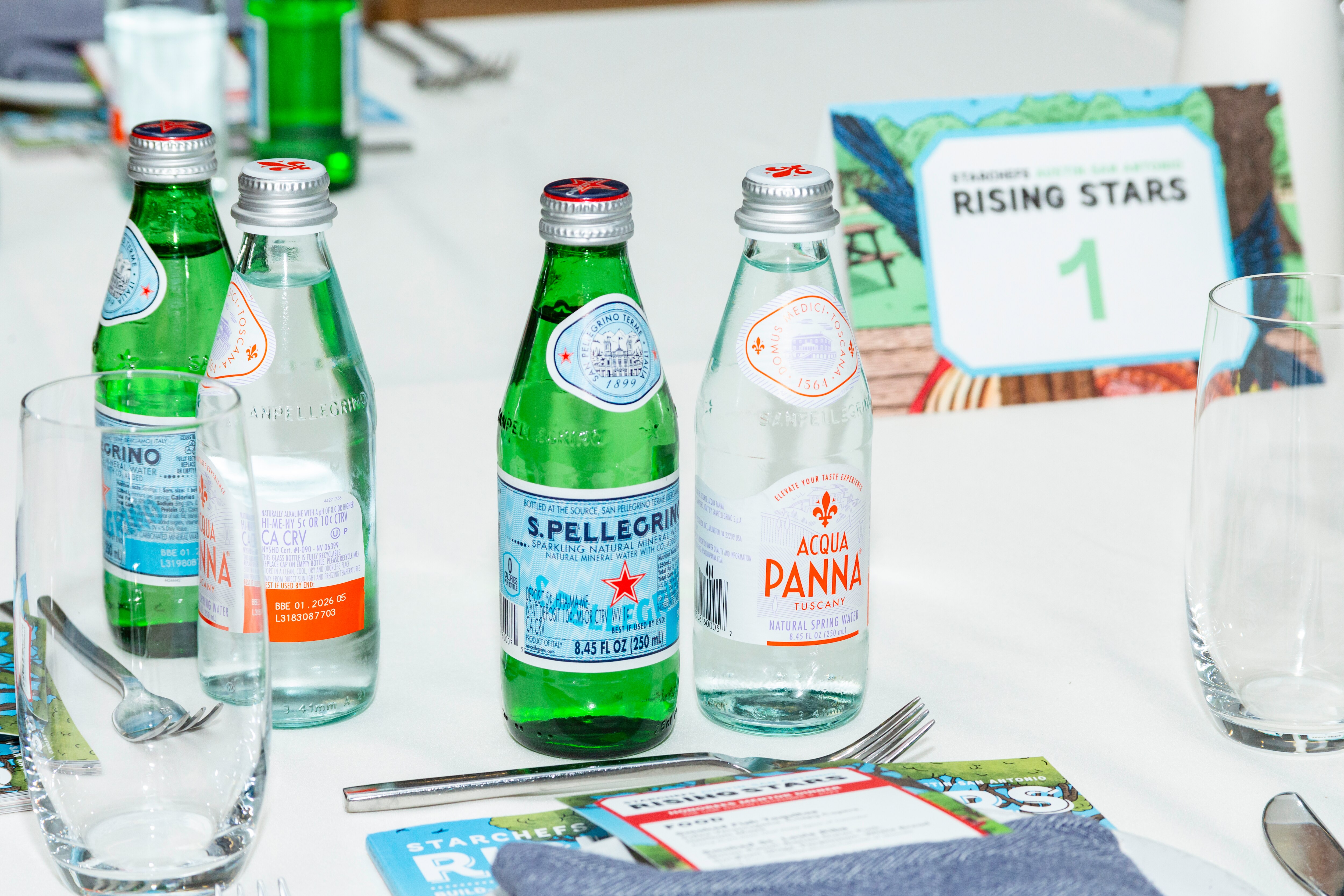 S.Pellegrino and Acqua Panna bottles at a table during the Rising Stars event.
