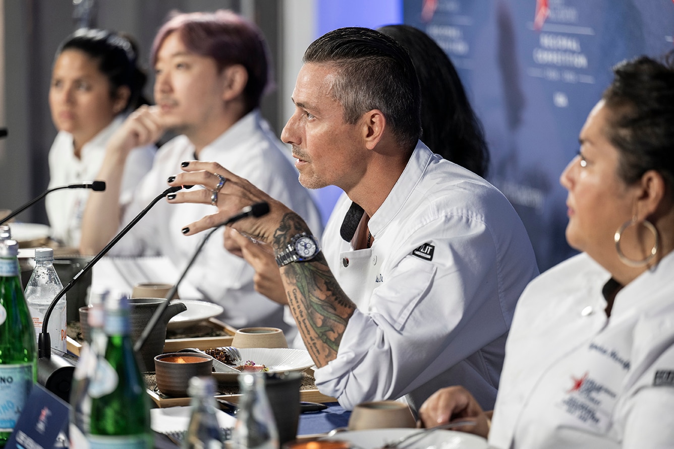 Chefs speak on a panel at a conference