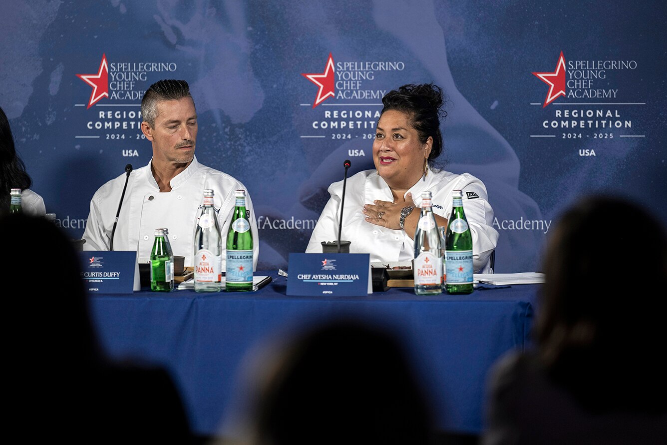 Chefs speak on a panel at a conference