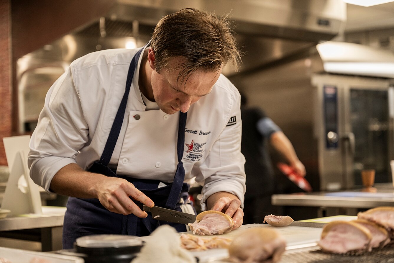 A chef works in an industrial kitchen