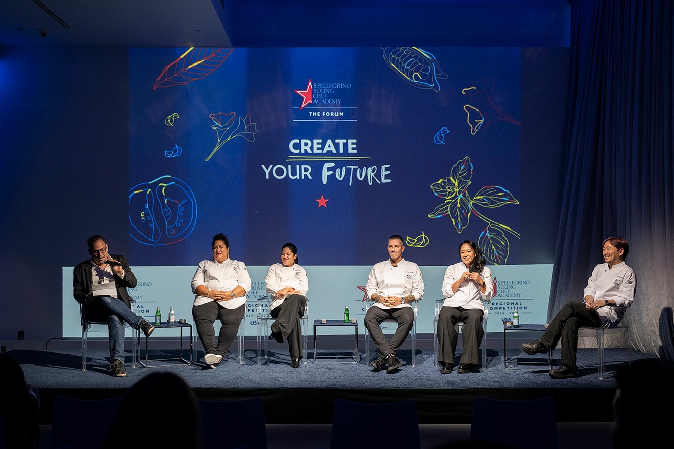 Chefs sit on a panel at a conference