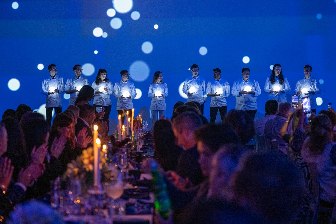 Chefs being toasted by an audience