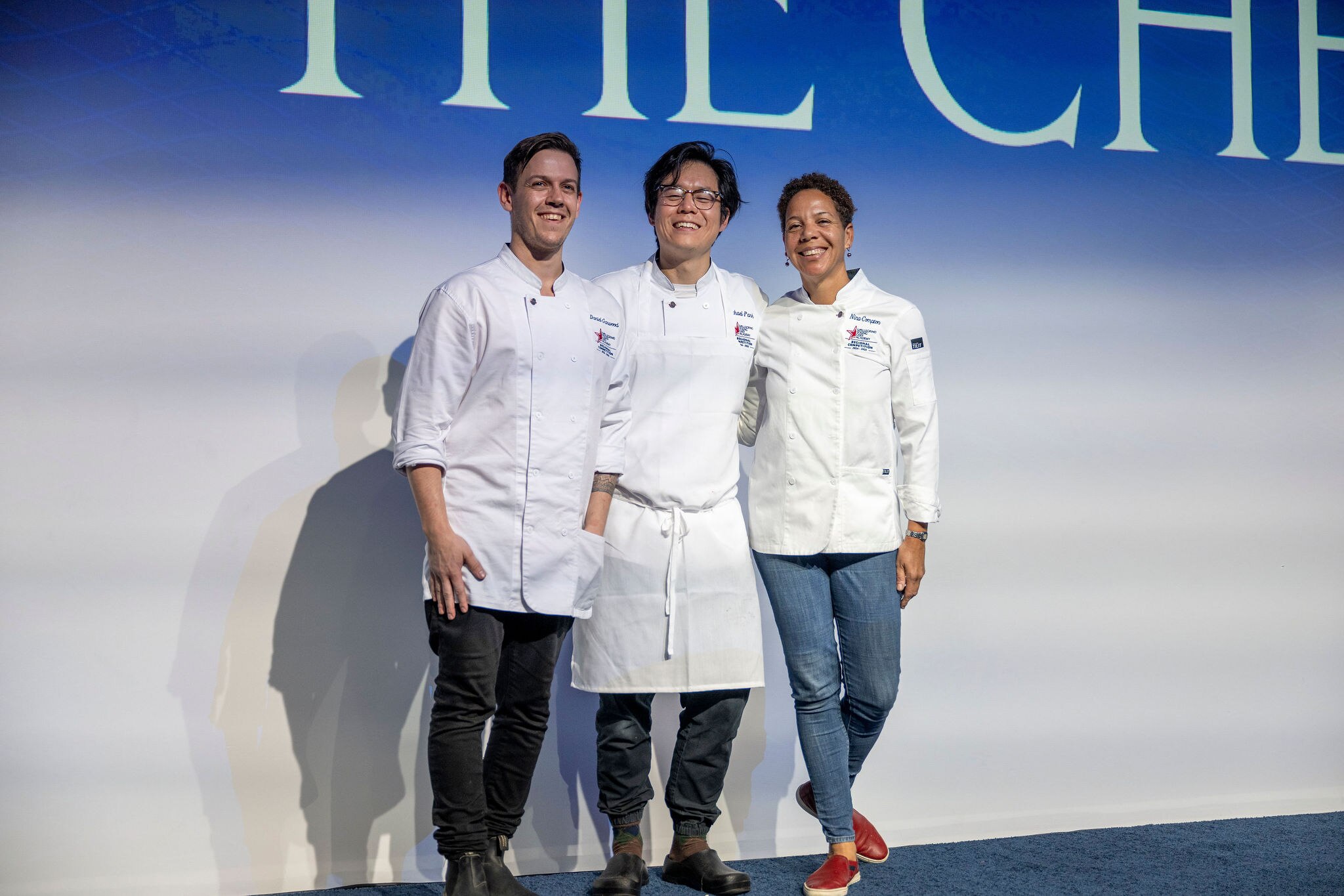 Chefs pose for the camera at a conference