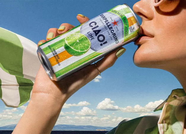 A girl sipping a can of Ciao! Lime flavor