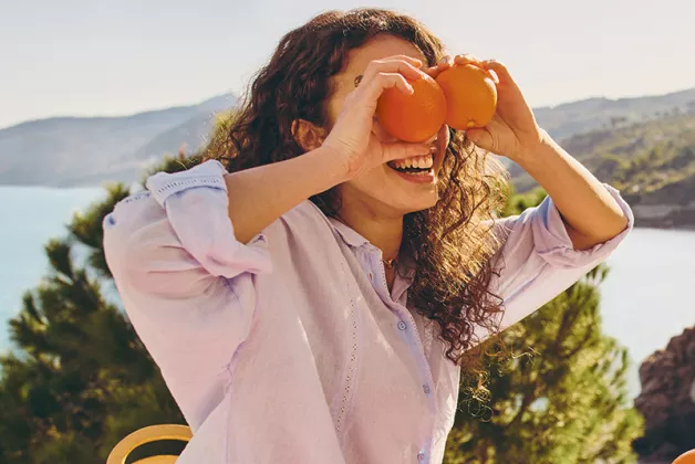 girl laying with oranges